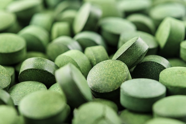 Chlorella or spirulina tablets close up. Texture of tablets spirulina or chlorella.