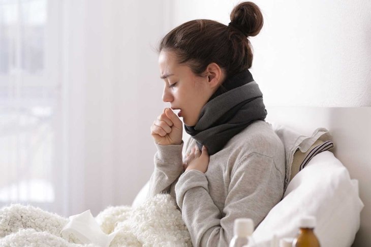 Young ill woman in bed at home